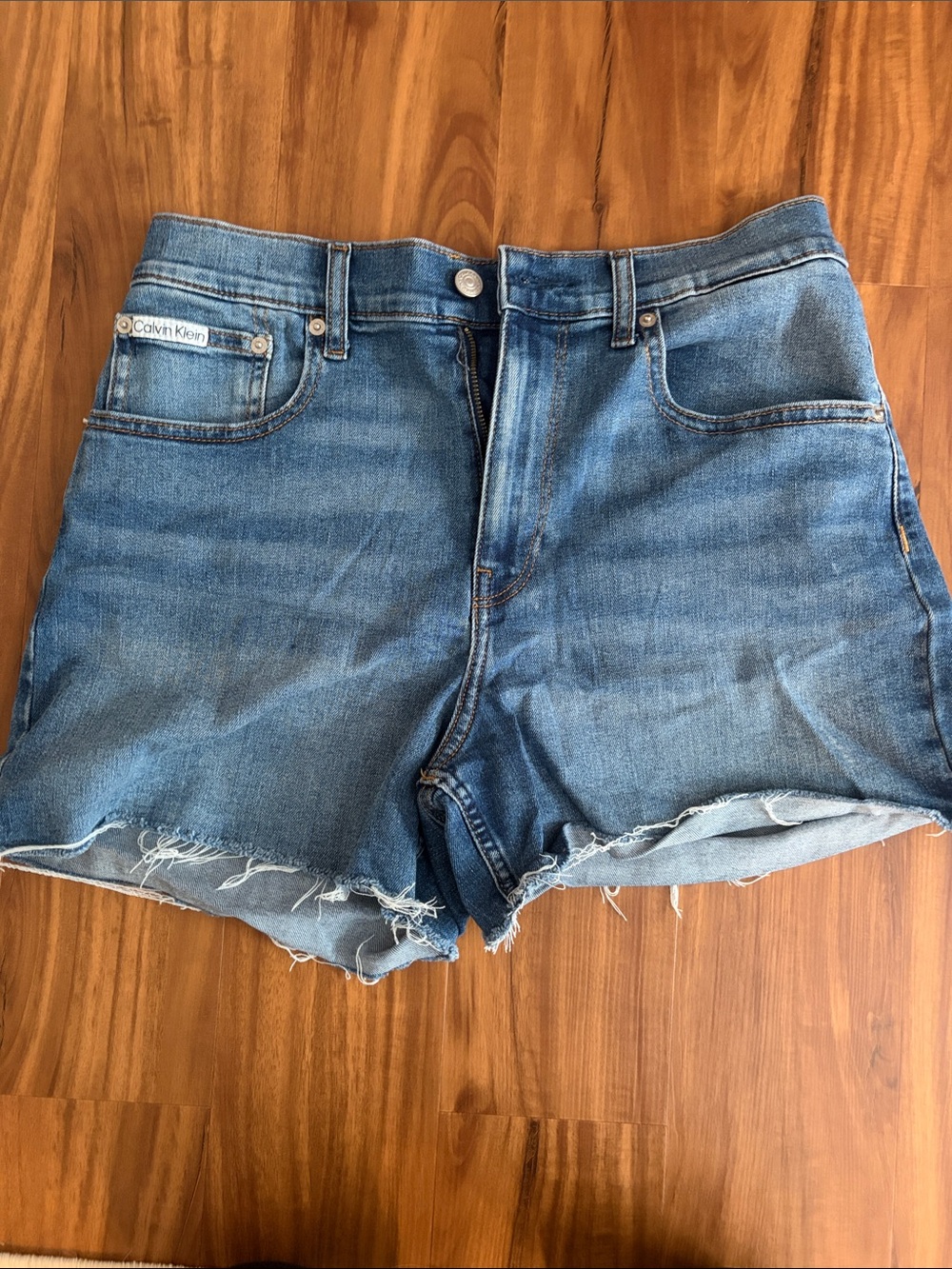 Calvin Klein Medium Blue Denim Cutoff Shorts with Frayed Hem